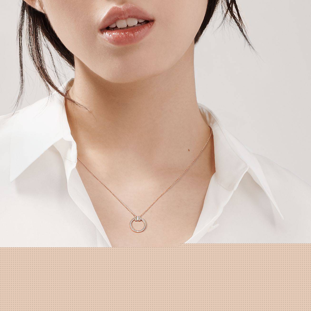 T*f*ny t diamond pendant in 18k rose gold with a baguette diamond